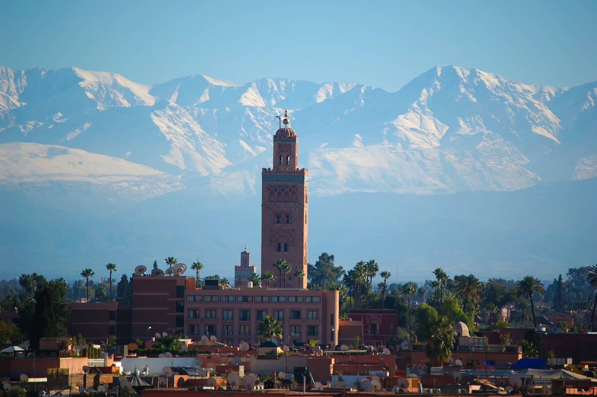 Vibrant cityscape of Marrakech with traditional Moroccan architecture, bustling streets, and the iconic red walls of the medina.