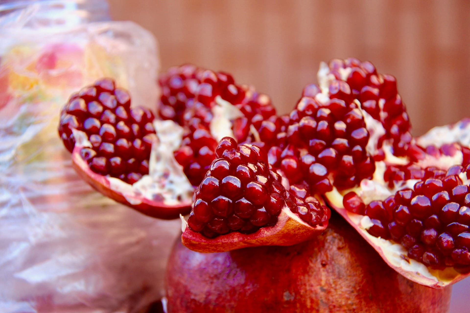 Fresh pomegranate fruit, a symbol of Moroccan cuisine, with its rich red seeds and natural beauty representing the region's agricultural heritage.